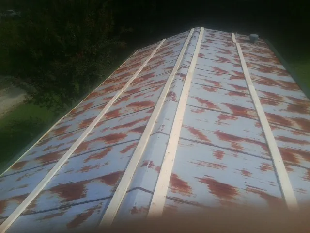 Rusted metal roof panels with new wood purlins before replacement — Storm Damage Roof Repair in Swannanoa by Roofing Brothers